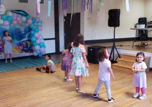 Backdrops, balloons, streamers and kids. What is this a party?